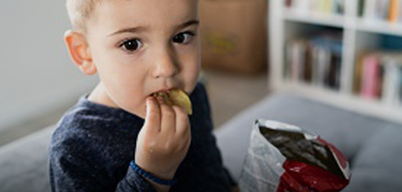 a little boy that is eating some food