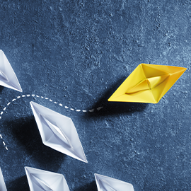 yellow boat going a different way to other boats