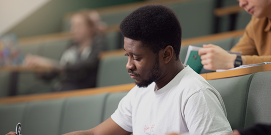 a person sitting at a table using a laptop