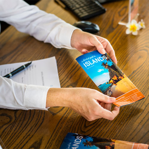 Someone holding tourism brochure 