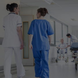 two nurses in a hospital corridor