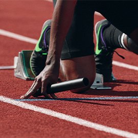 Man on the starting blocks of a running tracks