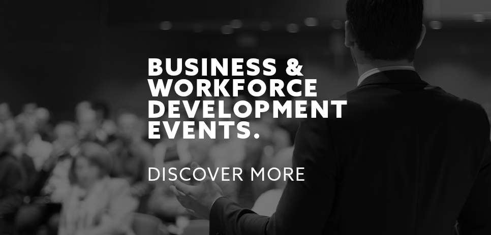 Business and workforce development events. Image of a business speaker in front of an audience.