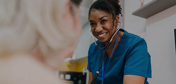 nurse helping a patient in a hospital setting