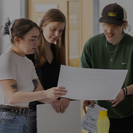 students looking at paper