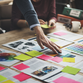 image of someone with post it notes on a table