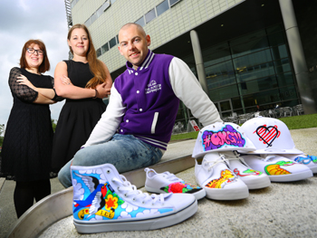 Caption: Senior lecturer Elaine Campbell and law student Natalie Baldwin with Neil Robinson from The Custom Underground 