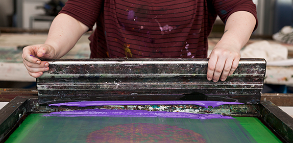 Close-up of a student using the fabric printing facilities.