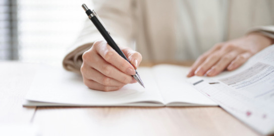 Person writing in a notebook