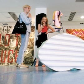 two people talking in an art gallery