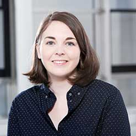 a woman standing in front of a building
