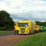 a truck driving down a dirt road