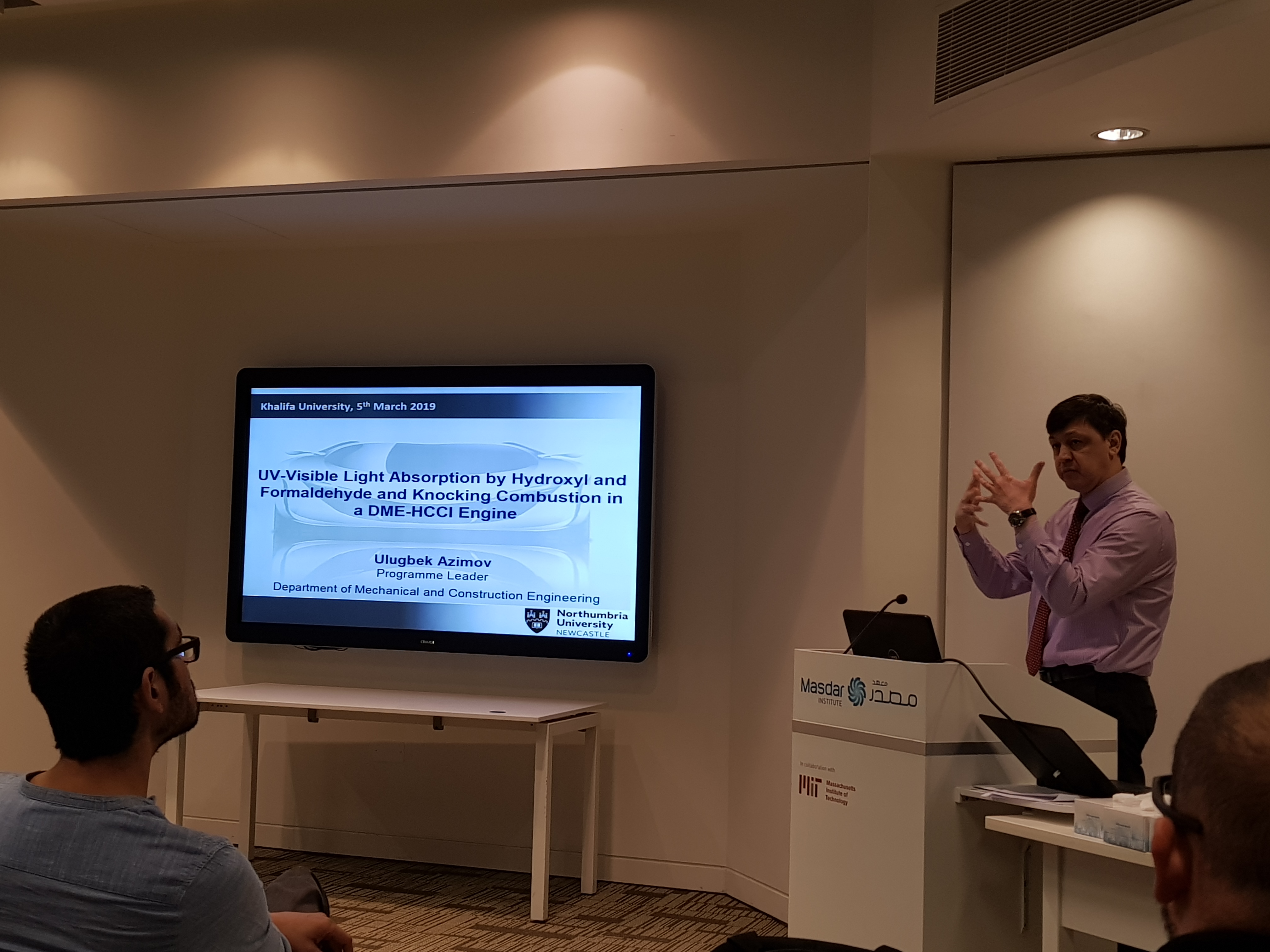 a man standing in front of a television playing a video game