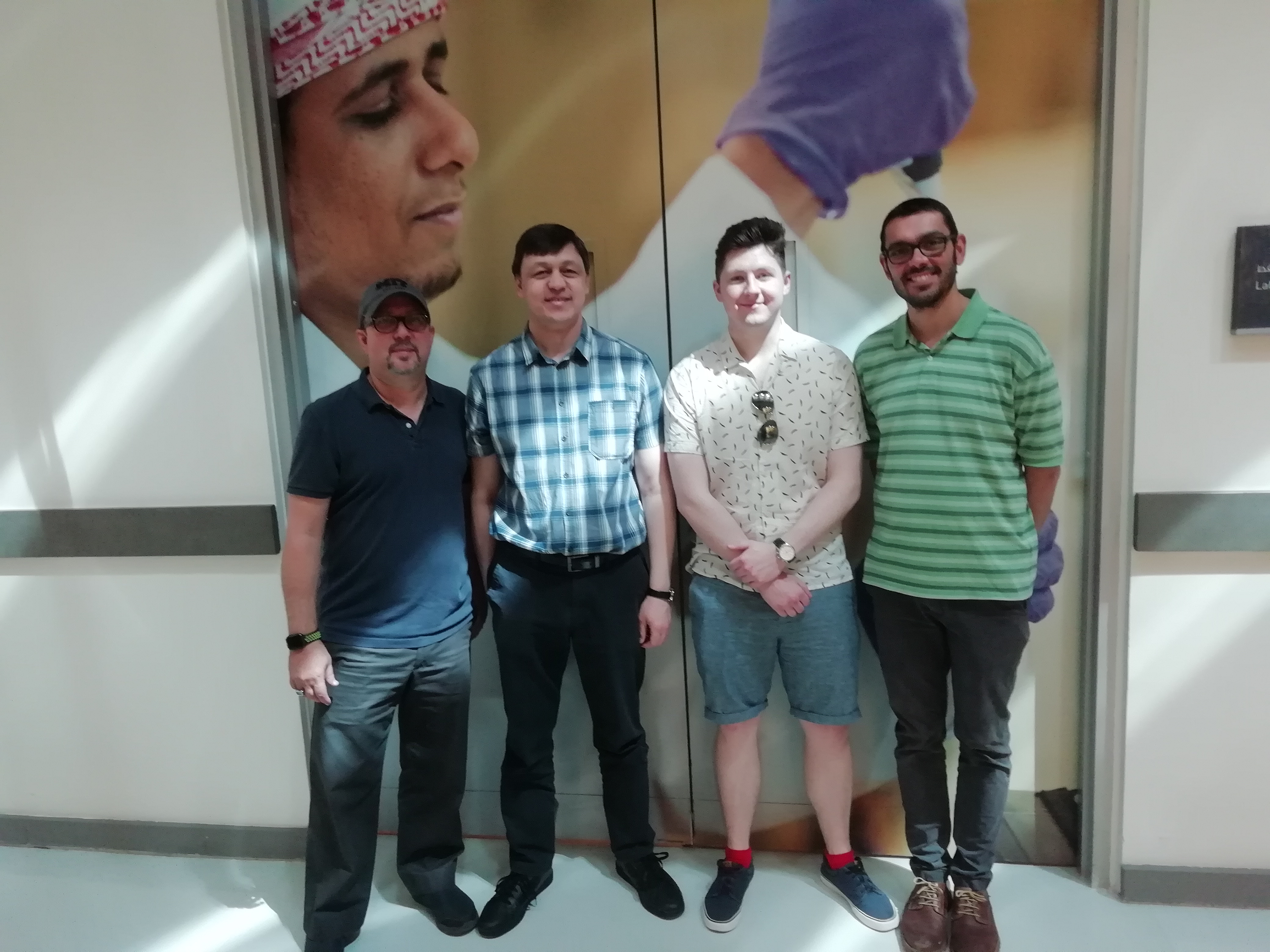 Hector H. Hernandez et al. standing in front of a mirror posing for the camera