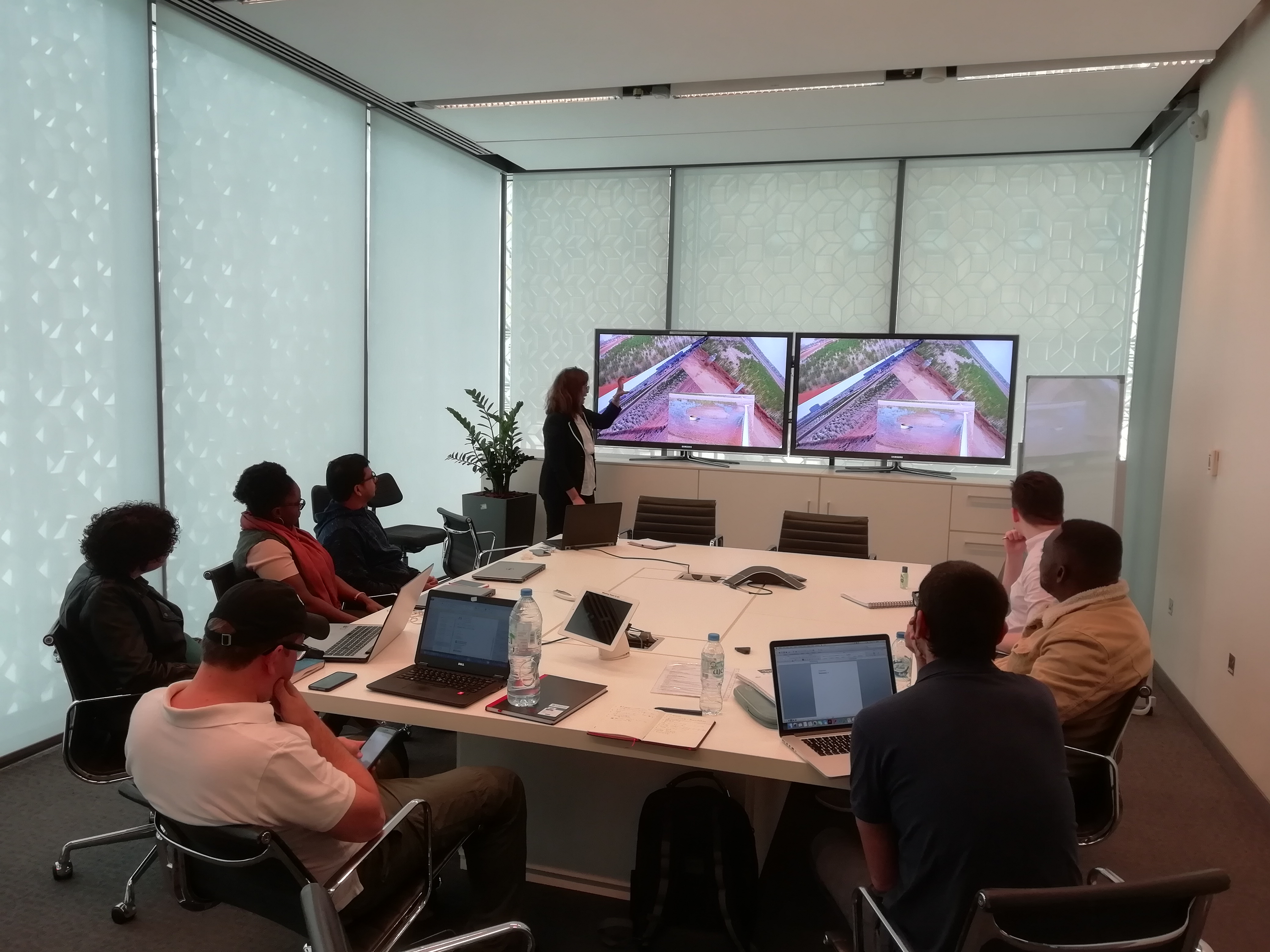 a group of people sitting at a desk in front of a computer