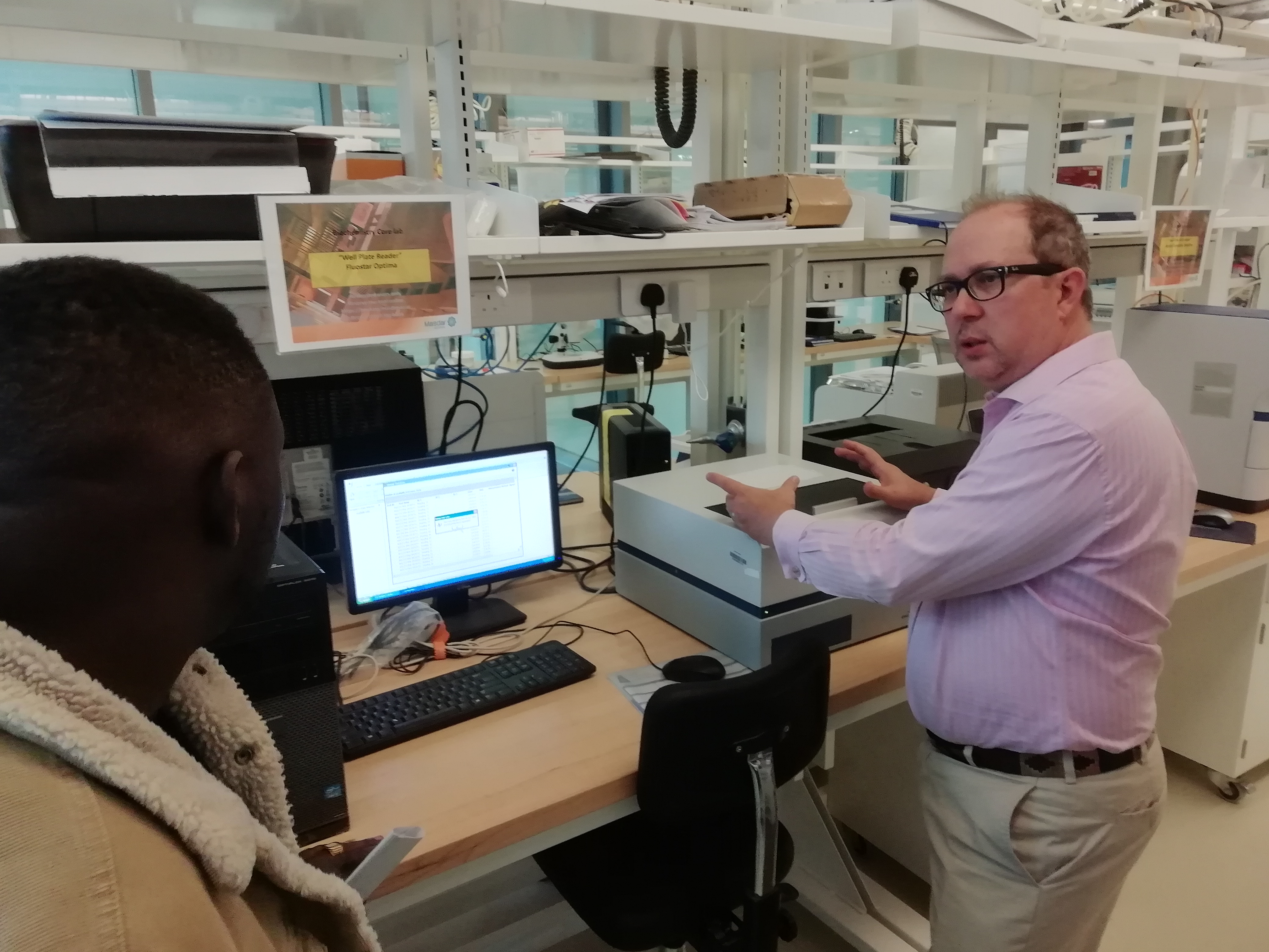 Hector H. Hernandez standing in front of a computer