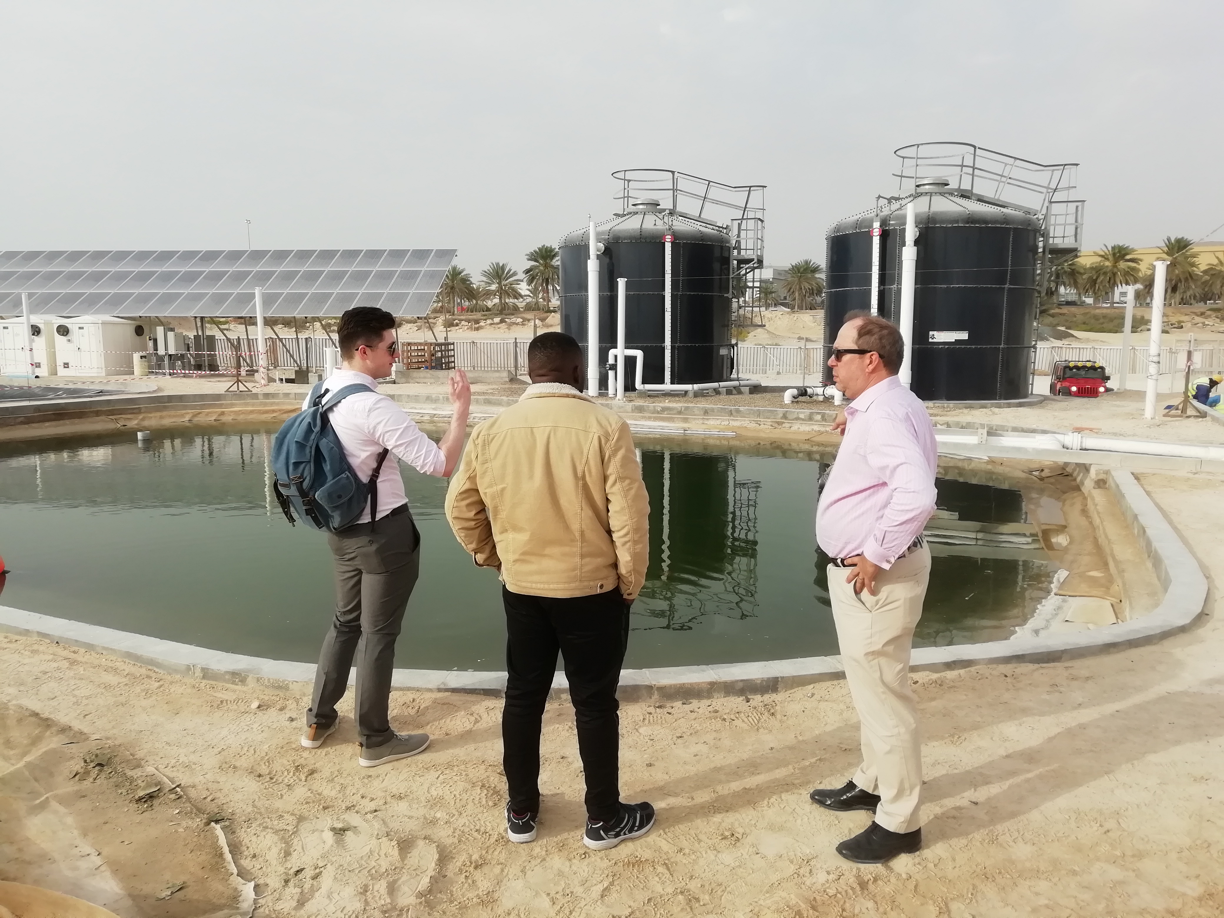 a group of people standing in a parking lot