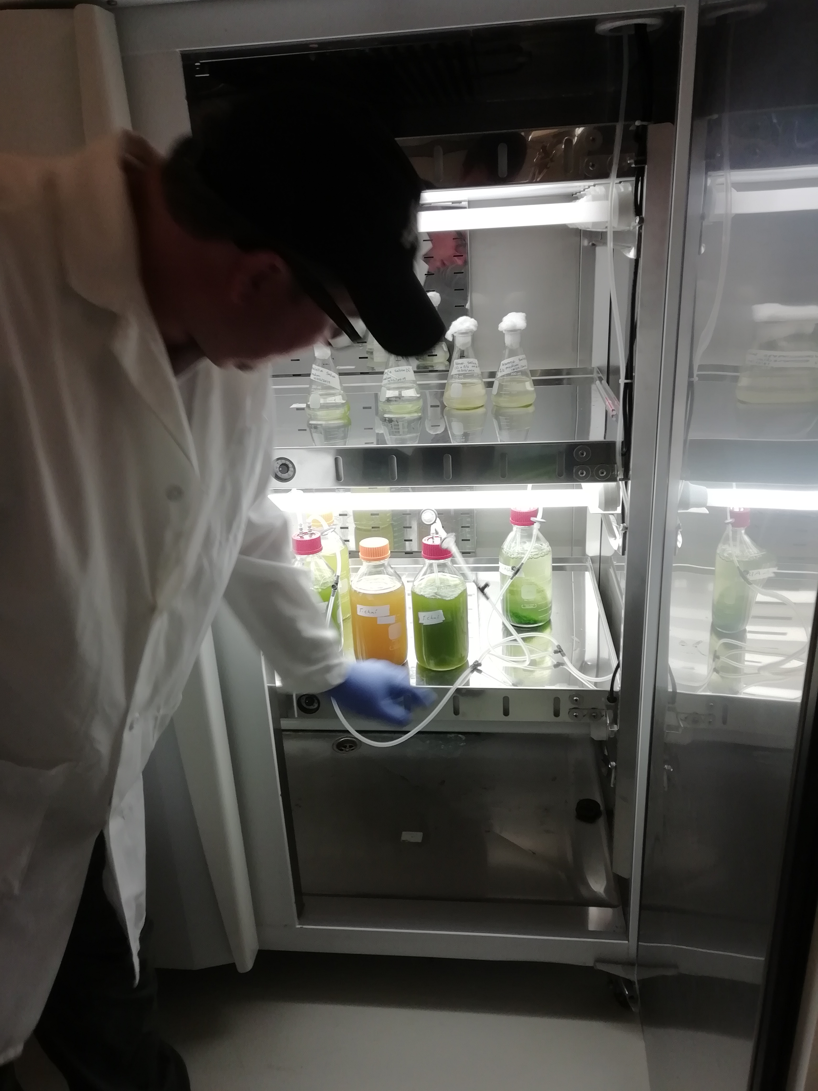 a man standing in front of a refrigerator with the door open