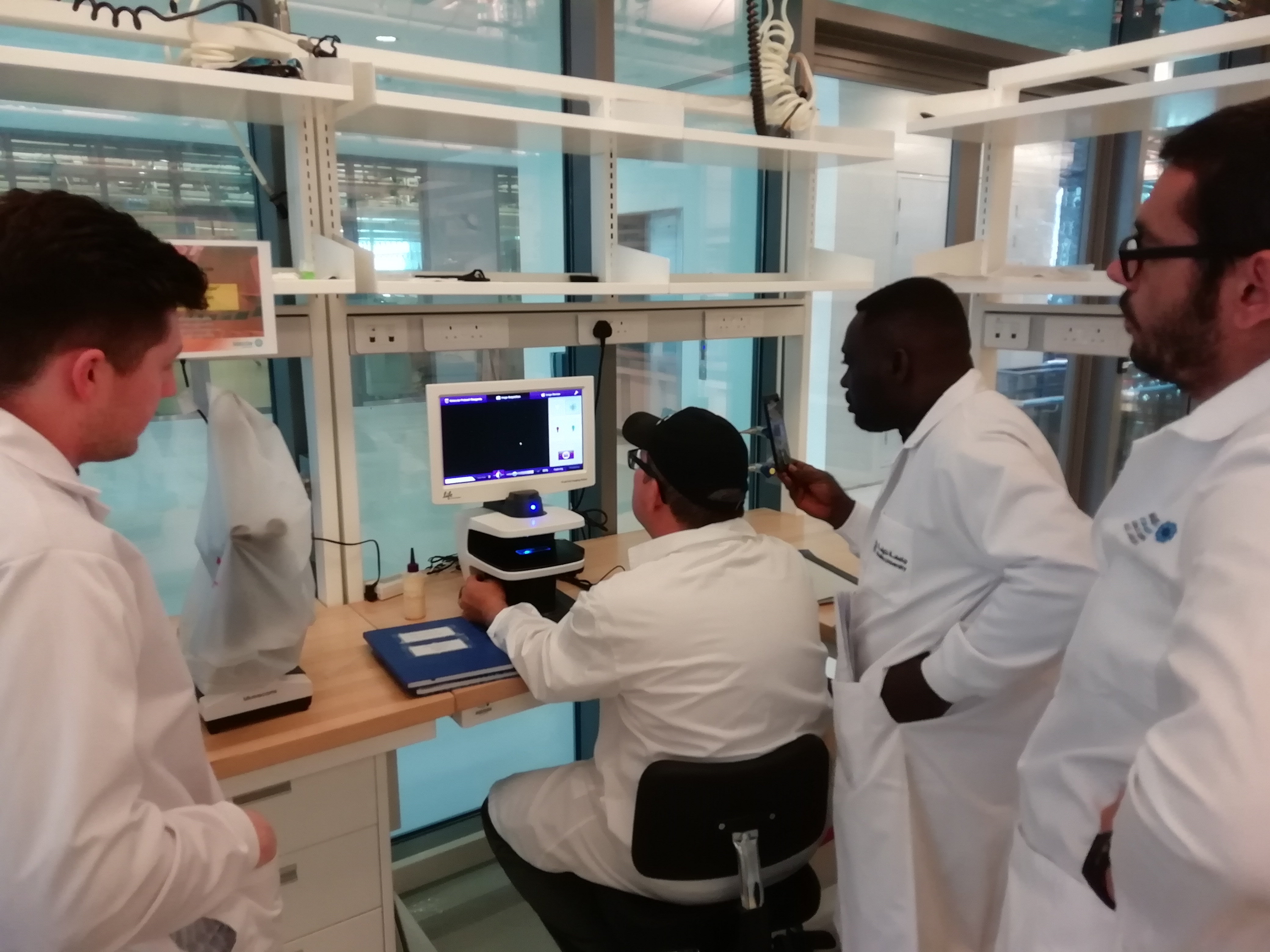 a group of people looking at a computer