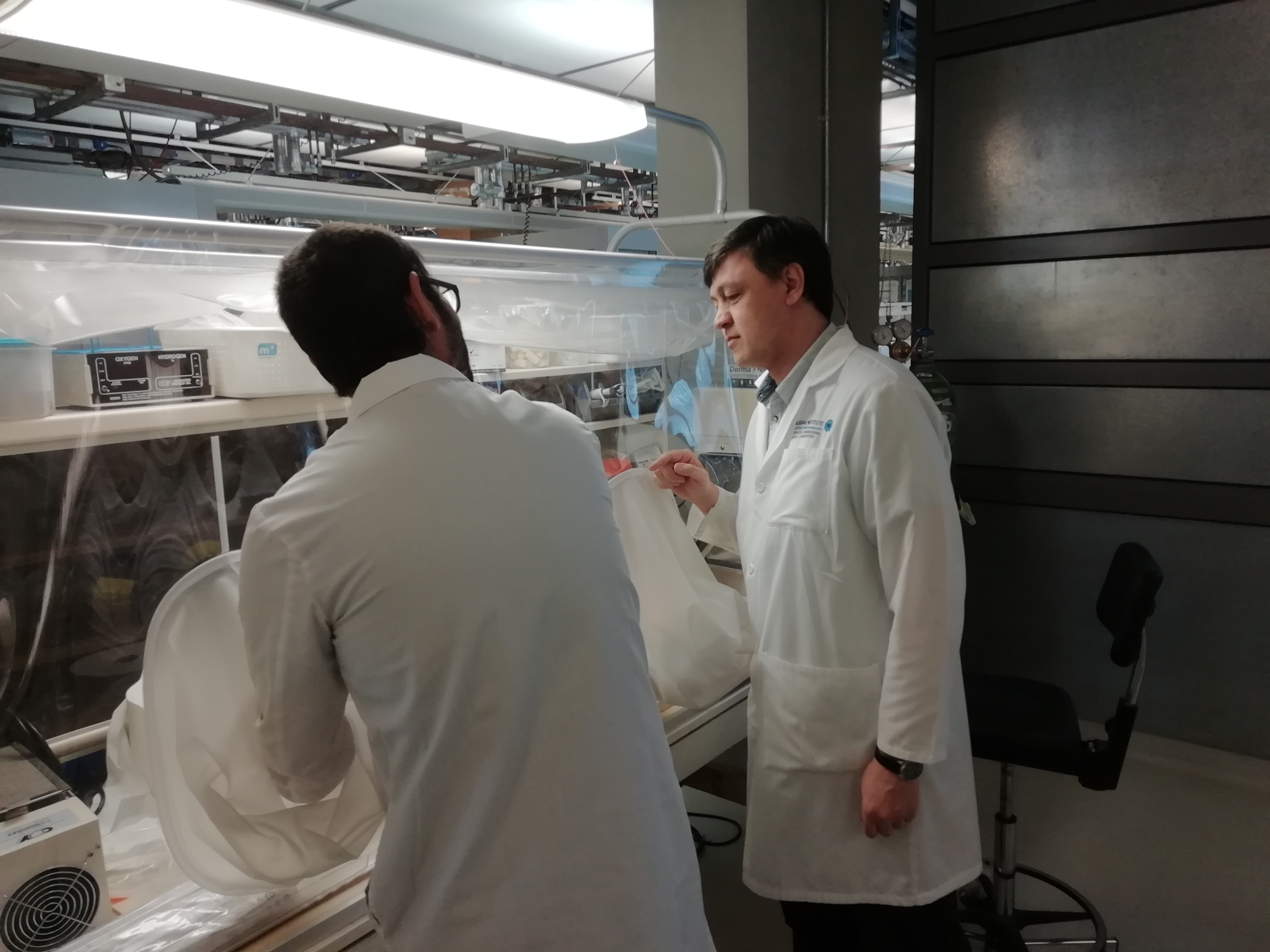 a group of people standing in a kitchen preparing food