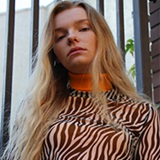 a woman standing in front of a window