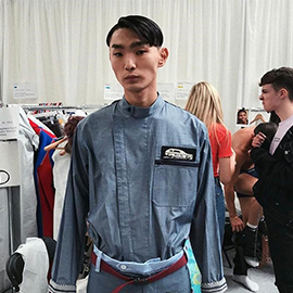 a group of people standing in front of a curtain