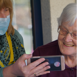 Elderly woman looking at a phone