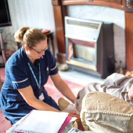 Nurse tending patient in their home