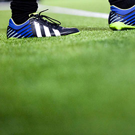 Football boots on a pitch