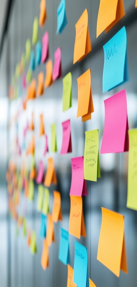 Brightly coloured post it notes  on a shiny black background