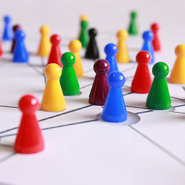 Multi- coloured board game counters on a white board