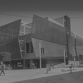 a person walking down a street next to a building