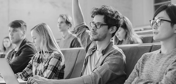 Students in a lecture, male student with hand raised 