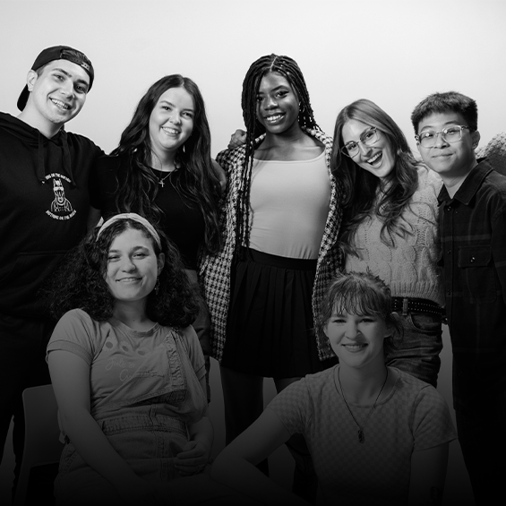 7 students all smiling and looking at the camera.