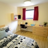 a bedroom with a bed in a room