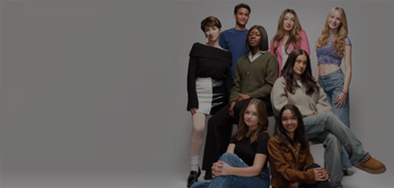 Image: Group of  Northumbria's Digital Content Creator students. They are looking directly at the camera and smiling. 