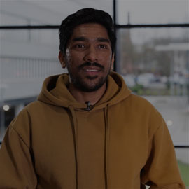 Current student from India, Nerius. Nerius is lookign directly at the camera and smiling.