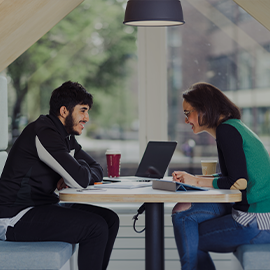 Two students working at desk