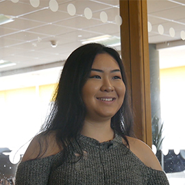 a woman standing in front of a window