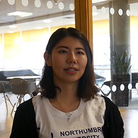 a woman standing in front of a window