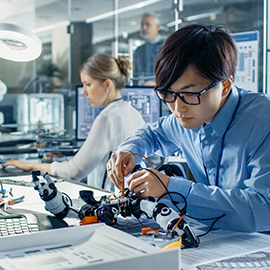 a man and a woman looking at a computer