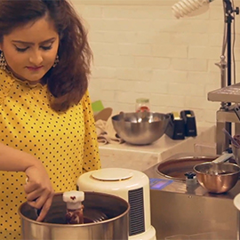 a woman preparing food in a kitchen