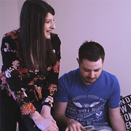 a man and a woman looking at the camera