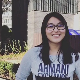 a person holding a sign posing for the camera