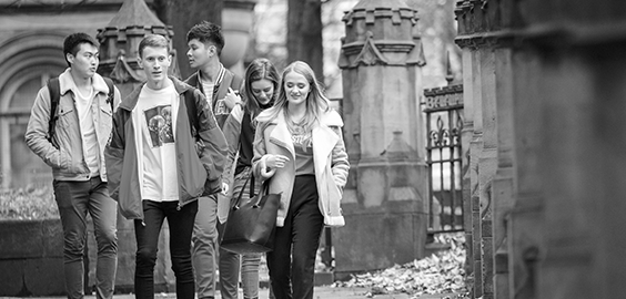 a group of people standing on a sidewalk