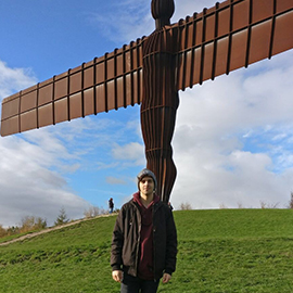 a person standing on top of a grass covered field