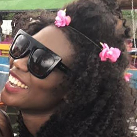 a woman wearing a hat and sunglasses