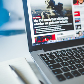 an open laptop computer sitting on top of a table