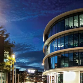a passenger bus that is parked on the side of a building