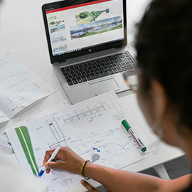 Woman working beside laptop